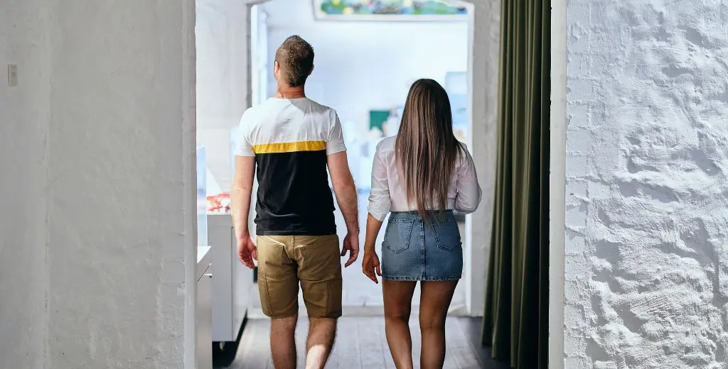Couple exploring the artworks in the Wadjemup Museum.