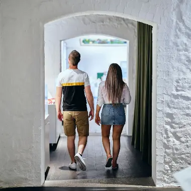 Couple exploring the artworks in the Wadjemup Museum.