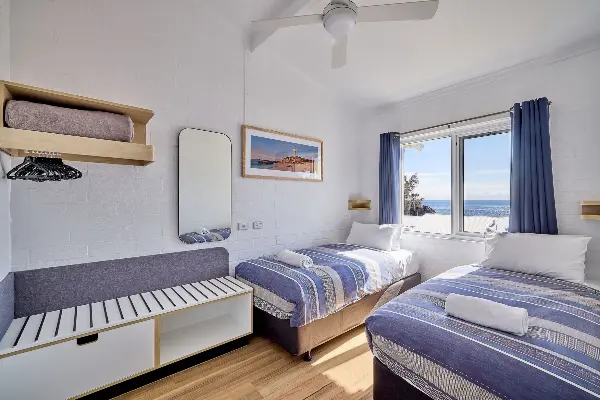 Shared bedroom with an ocean view from one of the newly refurbished Longreach Bay units.