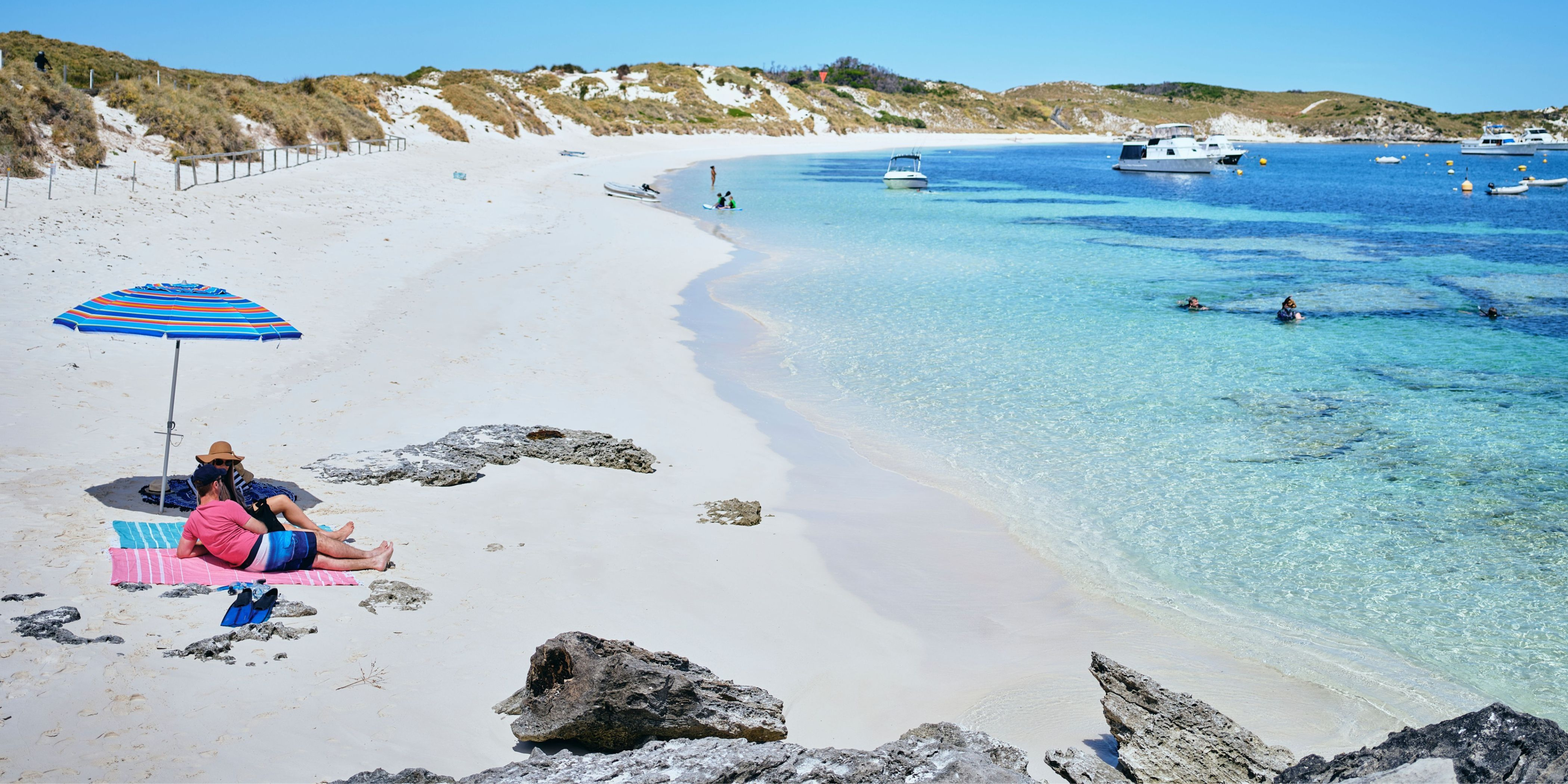 Couple relaxing on the beach at Rocky Bay