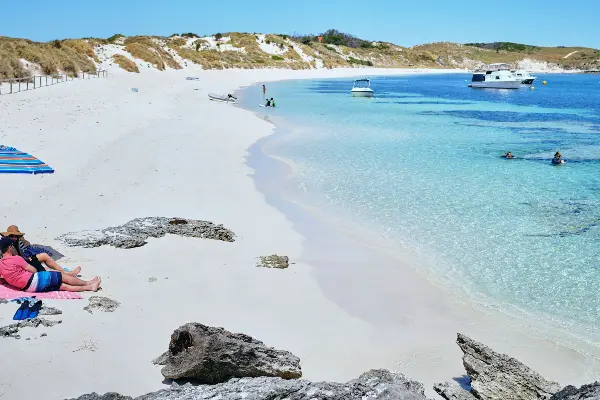 Couple relaxing on the beach at Rocky Bay