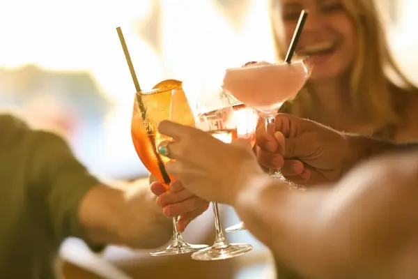 People sharing drinks at Sunsets Rottnest