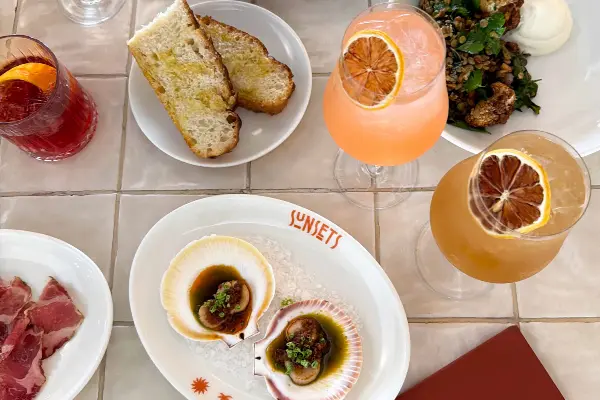 Plates of Oysters and snacks with drinks.
