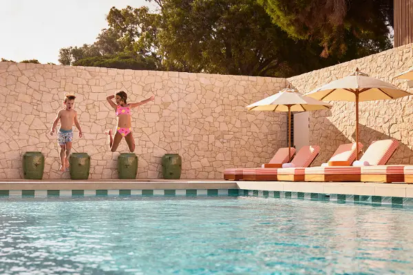 Kids jumping into the pool at The Lodge Wadjemup
