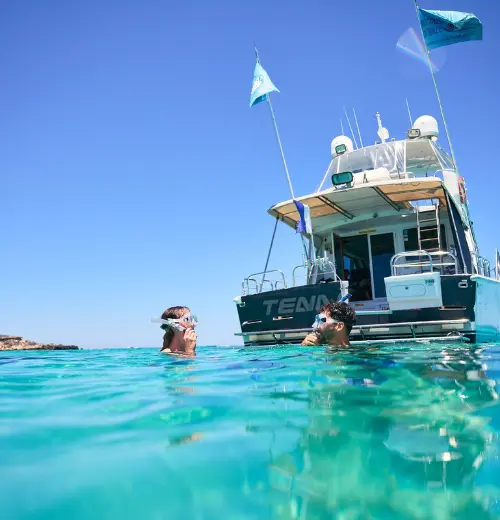 A couple in the water wearing snorkels