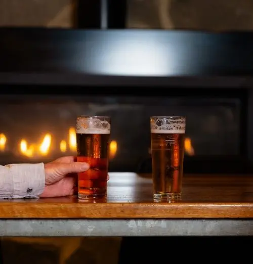 Two beers on a table.