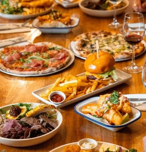 Different types of pub food spread across the table.