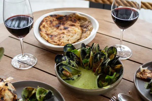 Green Curry Mussels in the centre of the table.