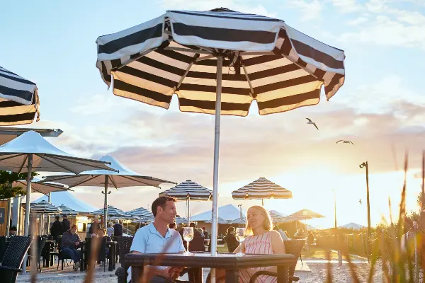 Couple sitting at table at sunset
