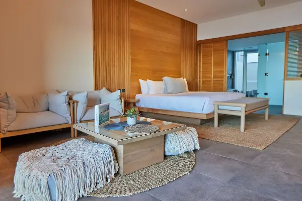 A room with a king bed and small sitting area.