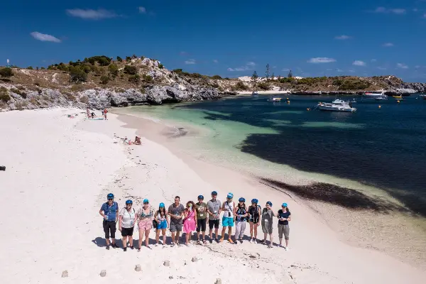 Group of people standing on the sand at the beach