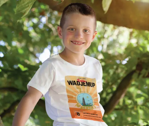 Child sitting in tree wearing travelling t-shirt design