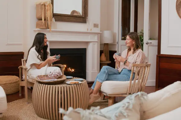 Two friends sitting by the fire place