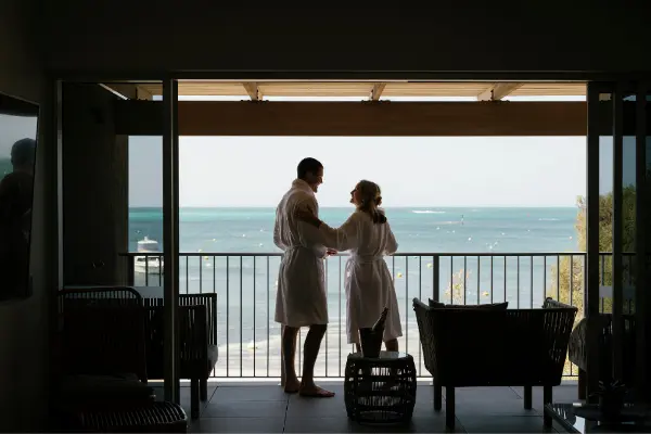 Couple standing on the balcony.